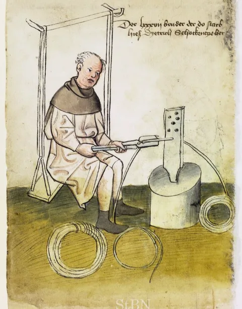 Dietrich the wire-drawer at work in a swing seat, with coils of wire on the floor, painted in Nuremberg around 1425.